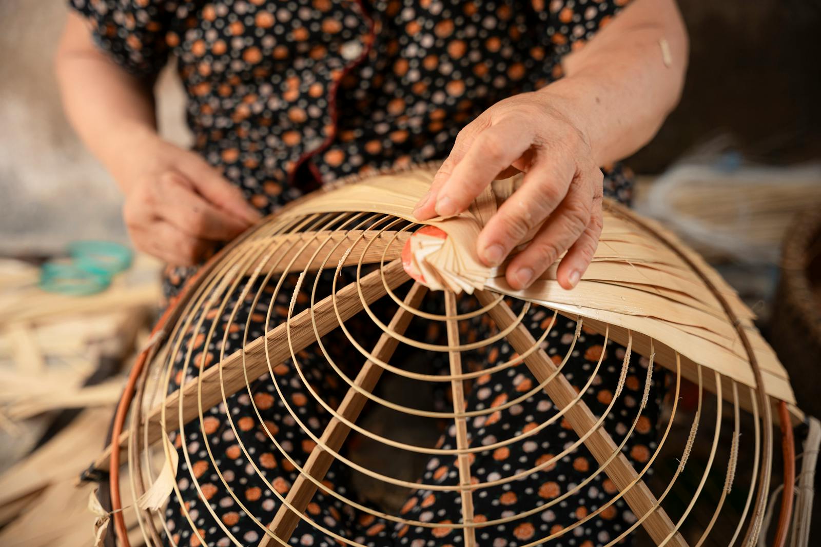 Close-up of artisan hands weaving a traditional bamboo basket