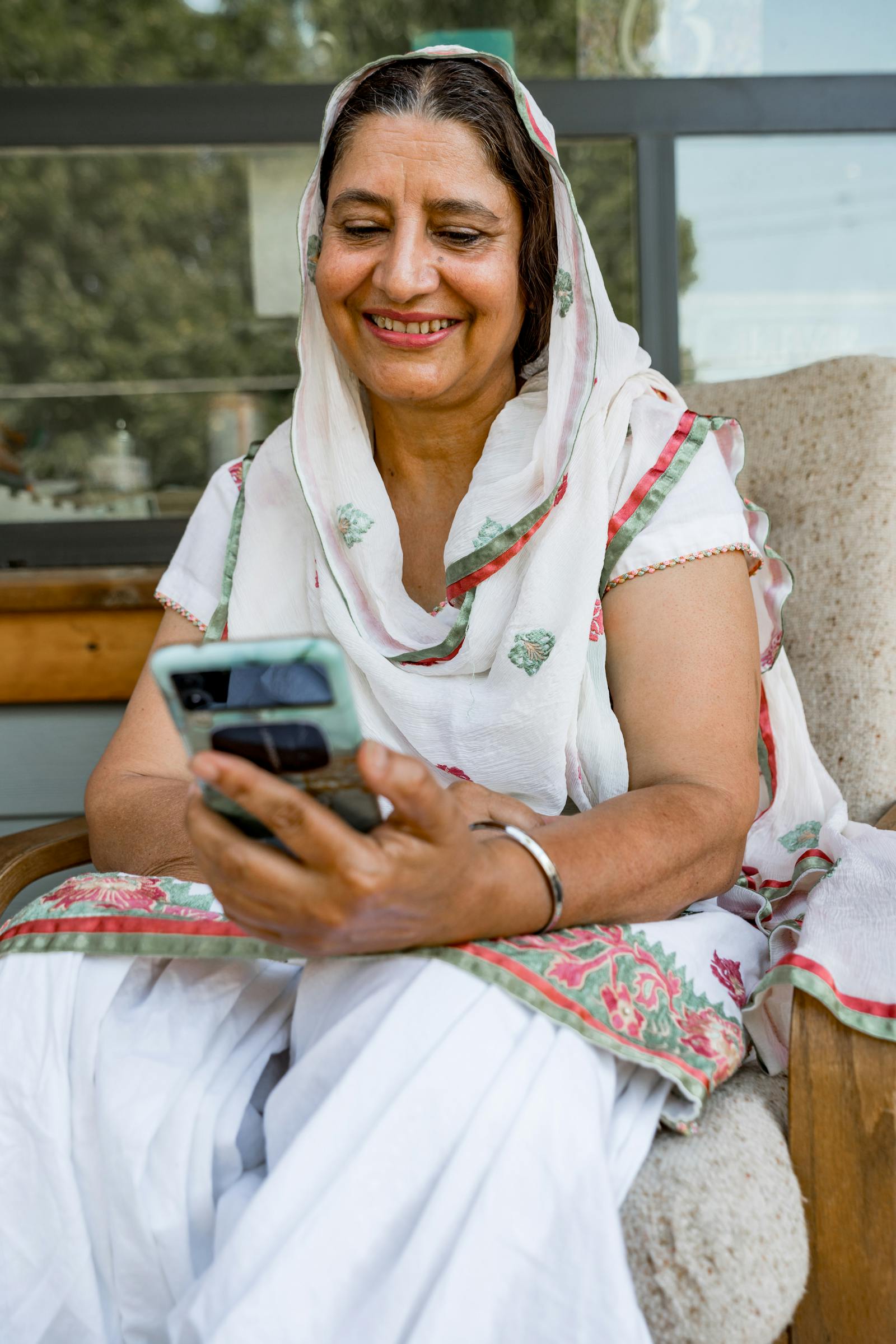 Indian woman in traditional dress learning on a smartphone